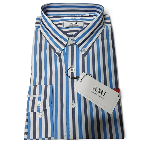 A folded long-sleeve button-down shirt with vertical blue, gray, and white stripes, featuring a white AMI brand hangtag attached.