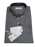 A folded Ami brand long-sleeve button-down shirt with thin vertical gray and white stripes, featuring a small red embroidered logo on the chest and a white hangtag.